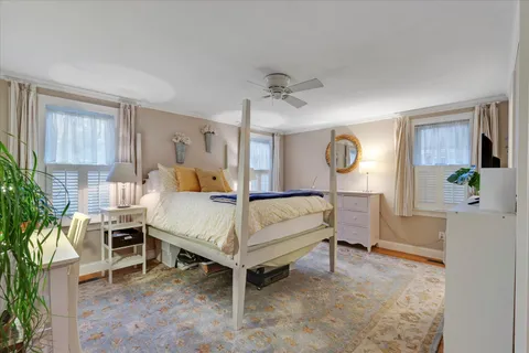 a bedroom with a large bed and a dresser