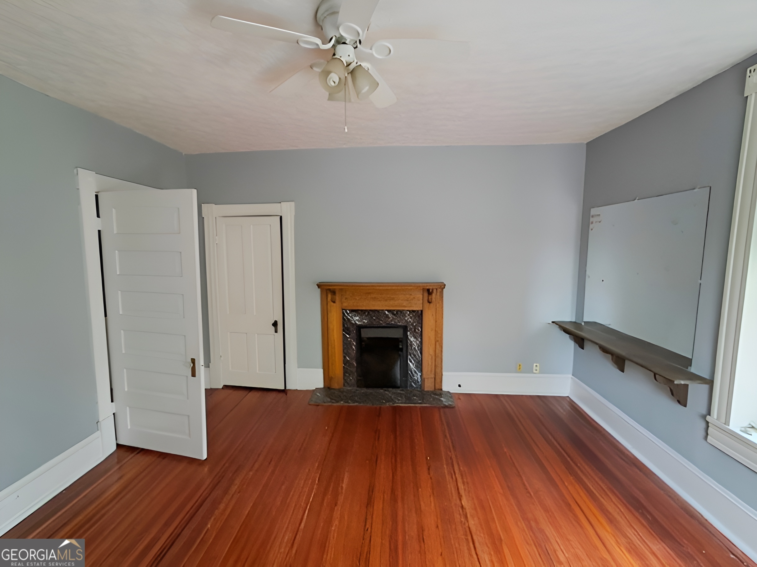 401 Forsyth Street Barnesville, GA 30204 - Photo 16 of 25 wooden floor fireplace and natural light in room