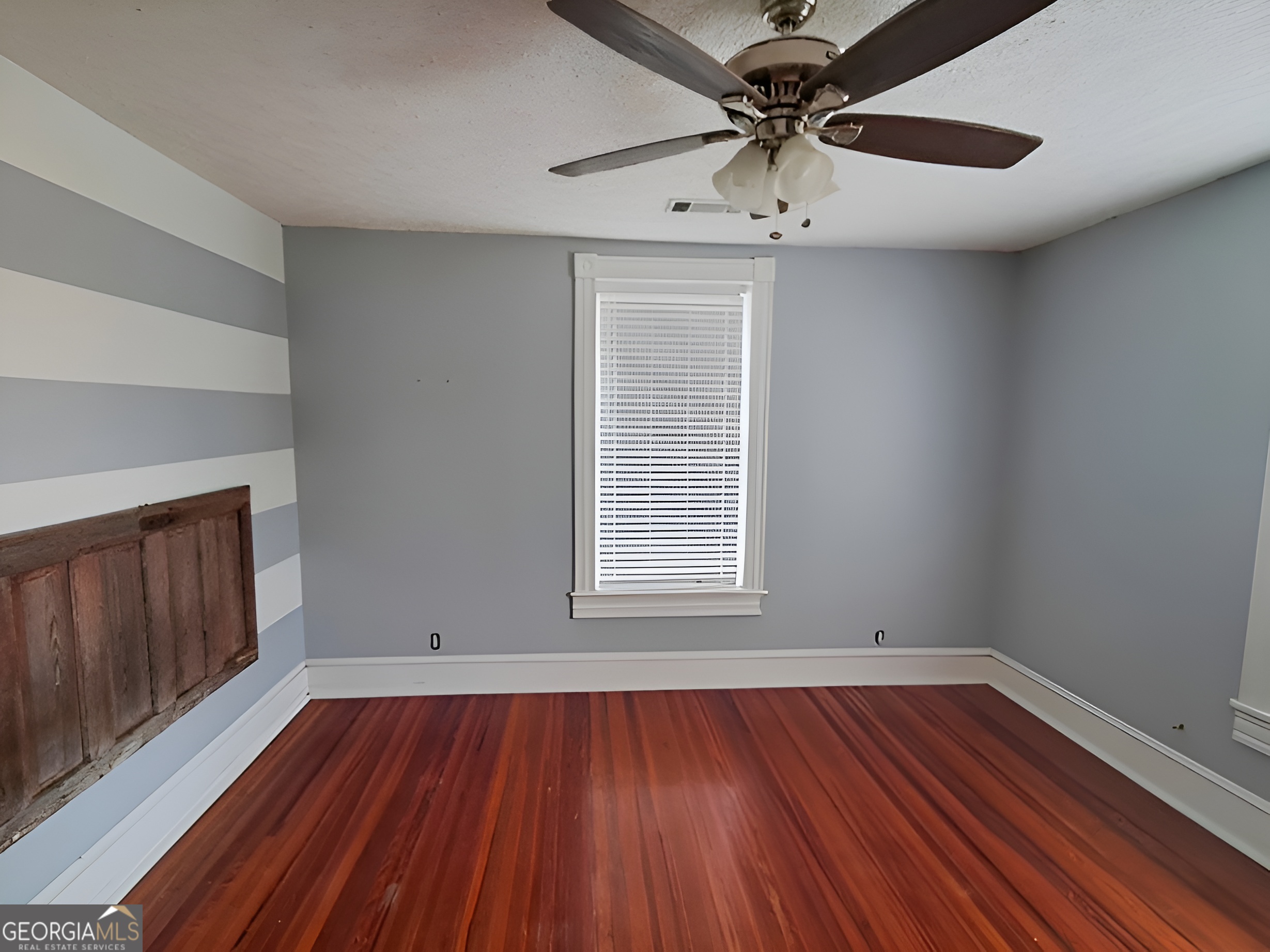 401 Forsyth Street Barnesville, GA 30204 - Photo 17 of 25 wooden floor in an empty room with a window