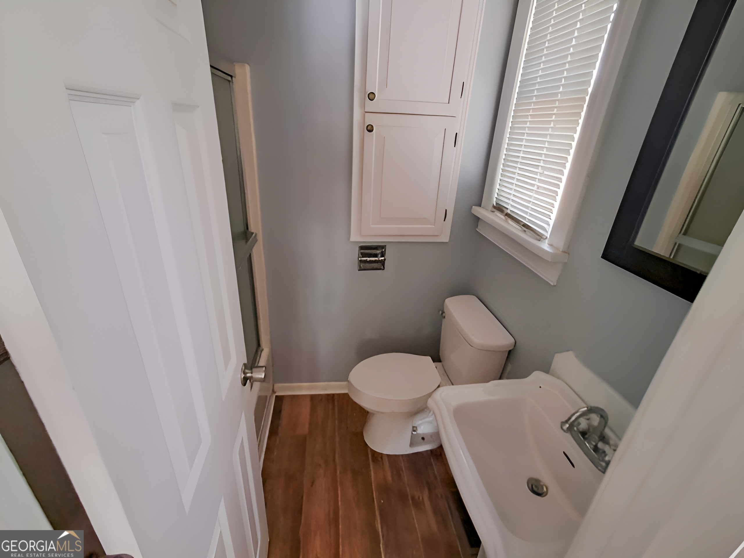 401 Forsyth Street Barnesville, GA 30204 - Photo 19 of 25 a bathroom with a toilet sink and shower curtain