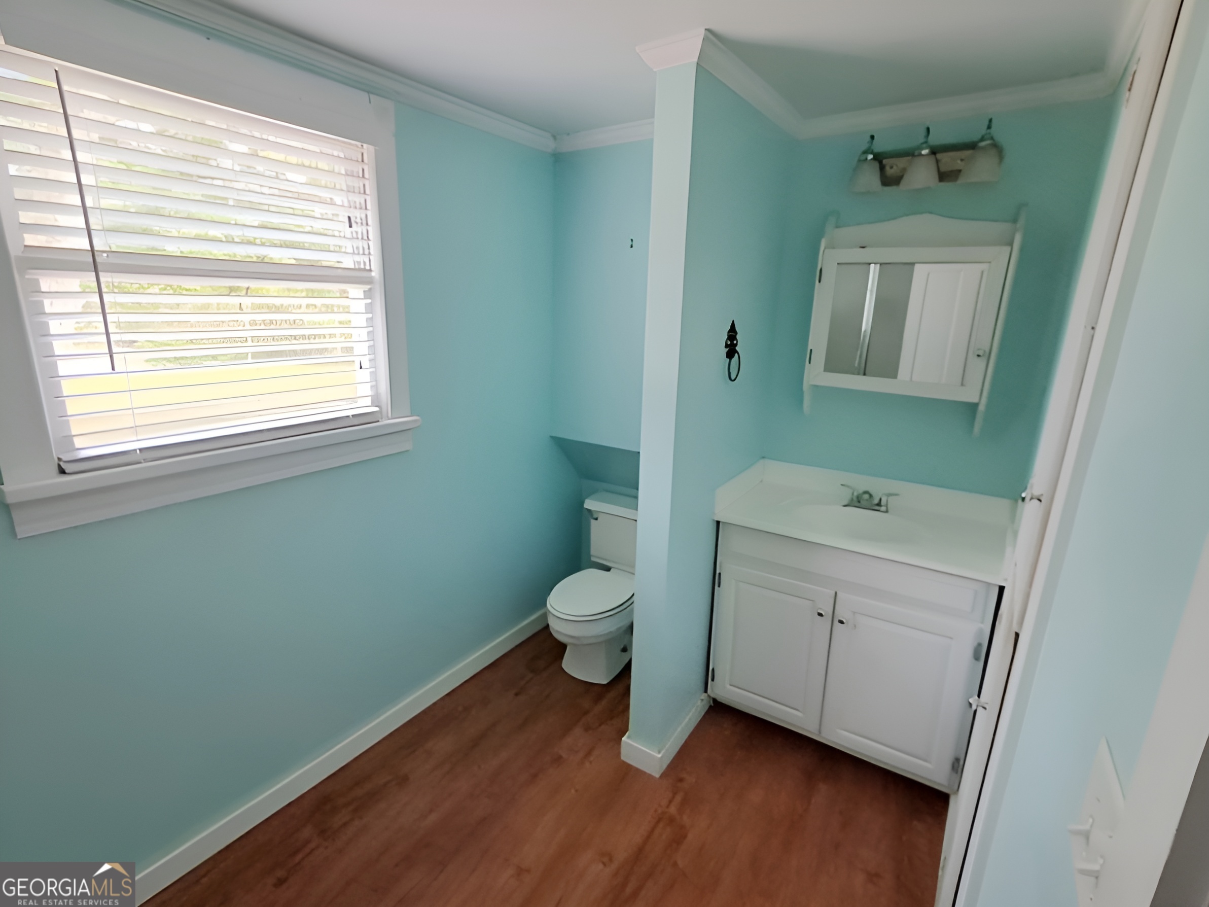401 Forsyth Street Barnesville, GA 30204 - Photo 20 of 25 a bathroom with a toilet sink and mirror