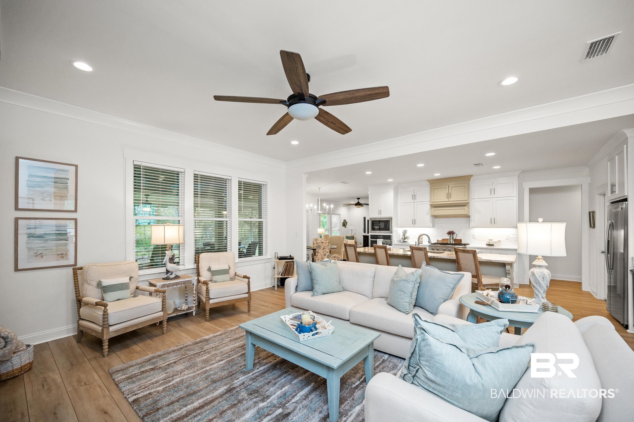 4601 Surrey Lane Orange Beach, AL 36561 - Photo 8 of 43 Living room with ceiling fan, ornamental molding, and wood-type flooring