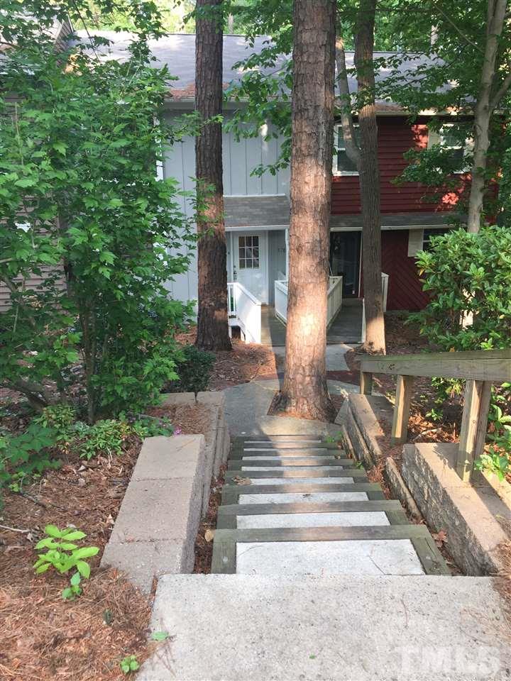 5702 3 Oaks Drive Raleigh, NC 27612 - Photo 1 of 18 a front view of a house with garden