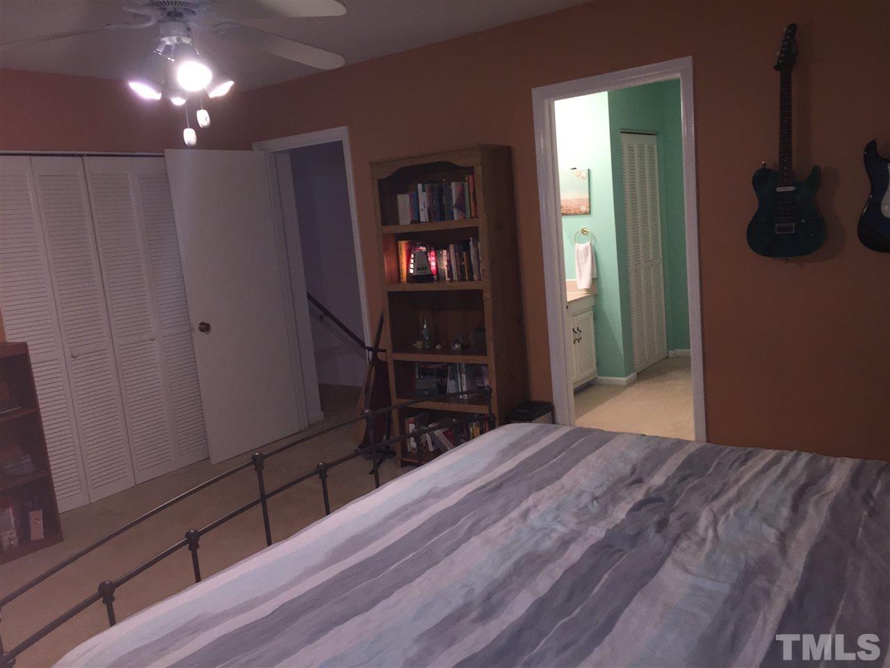 5702 3 Oaks Drive Raleigh, NC 27612 - Photo 11 of 18 a bedroom with a bed and a television in it