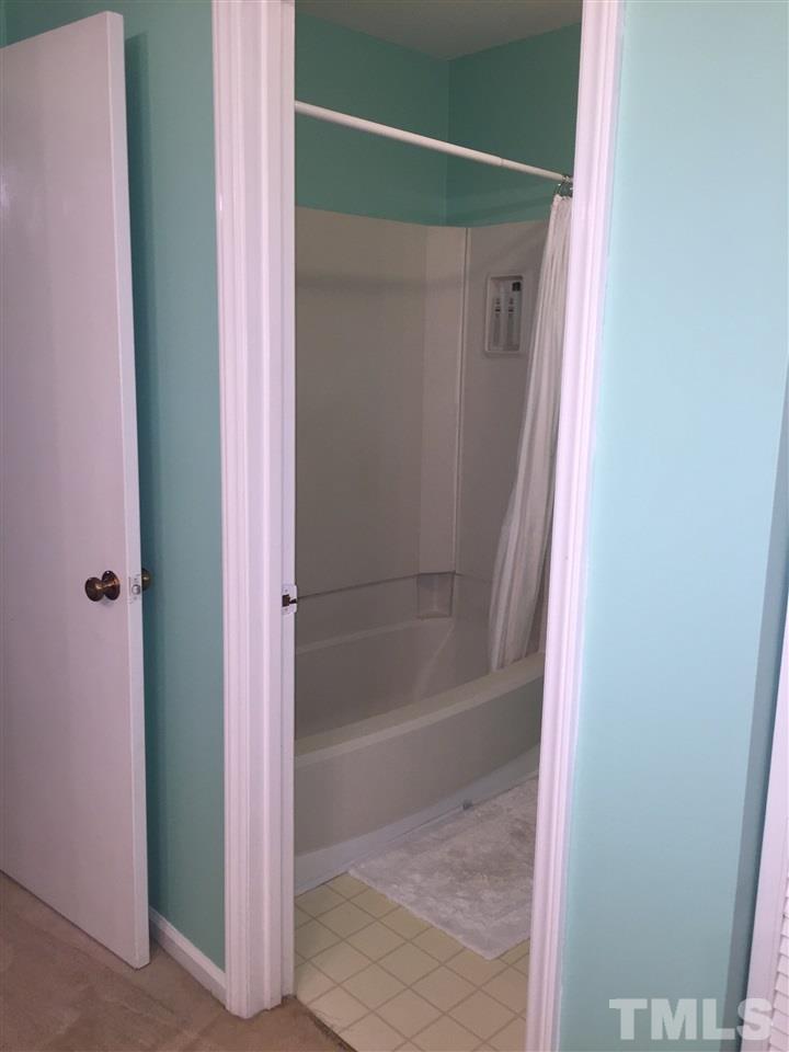 5702 3 Oaks Drive Raleigh, NC 27612 - Photo 14 of 18 a bathroom with a glass shower door