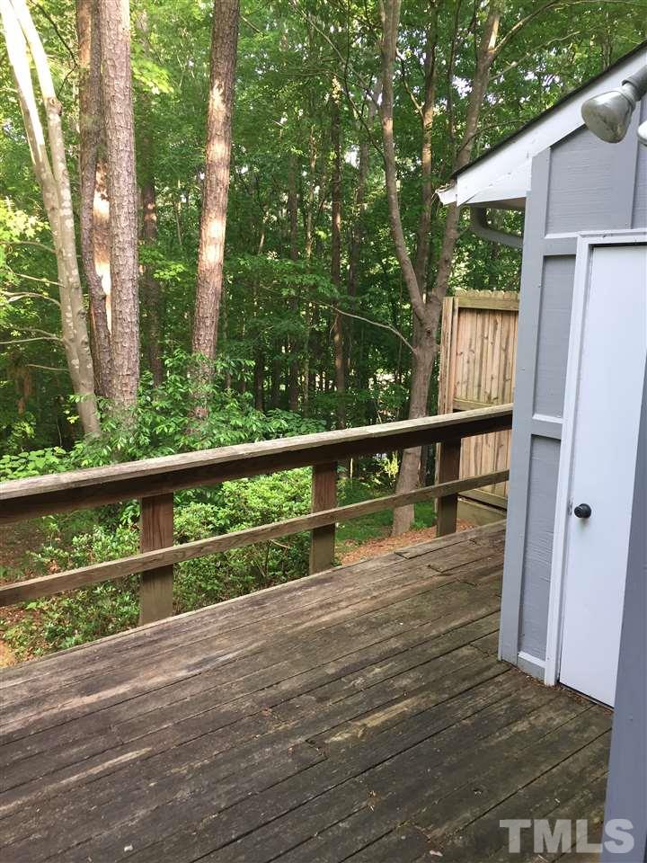 5702 3 Oaks Drive Raleigh, NC 27612 - Photo 18 of 18 a view of a wooden deck and a yard