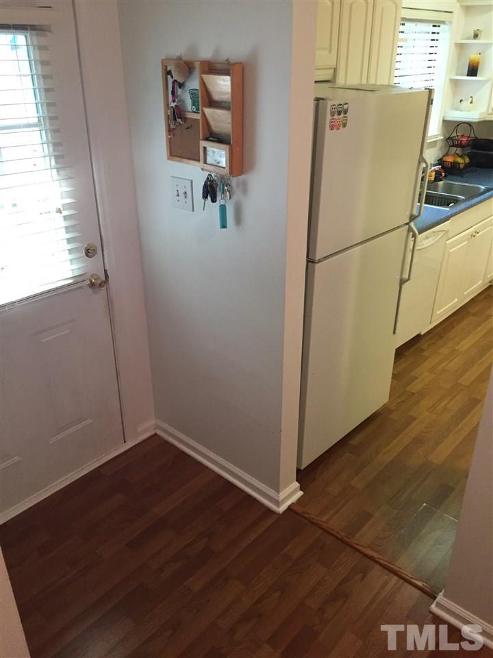 5702 3 Oaks Drive Raleigh, NC 27612 - Photo 3 of 18 an empty room with wooden floor and windows