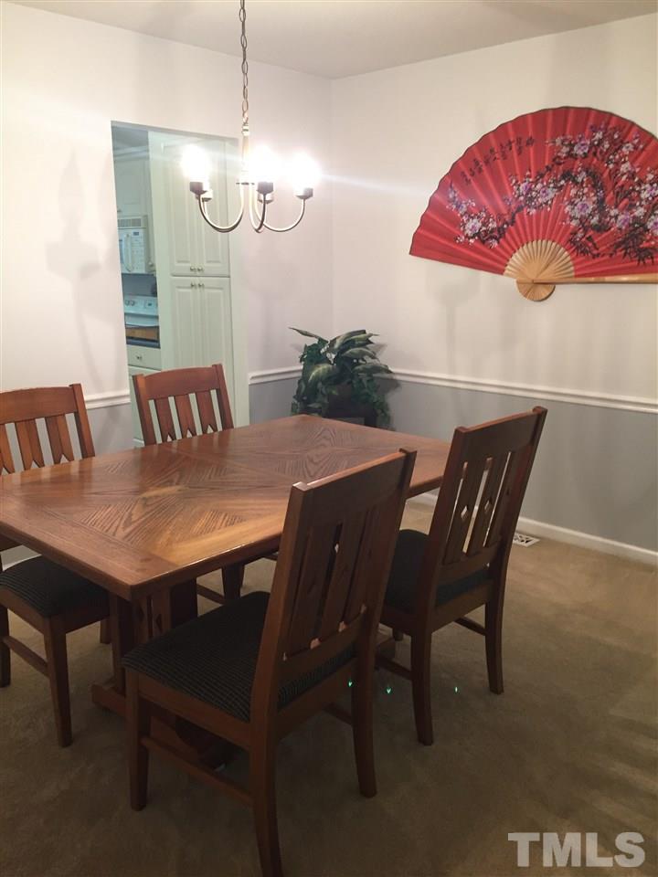 5702 3 Oaks Drive Raleigh, NC 27612 - Photo 6 of 18 a view of a dining room with furniture