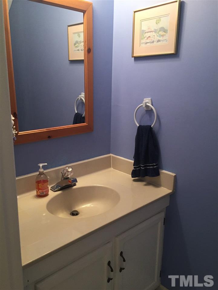 5702 3 Oaks Drive Raleigh, NC 27612 - Photo 8 of 18 a bathroom with a sink and a wall painting