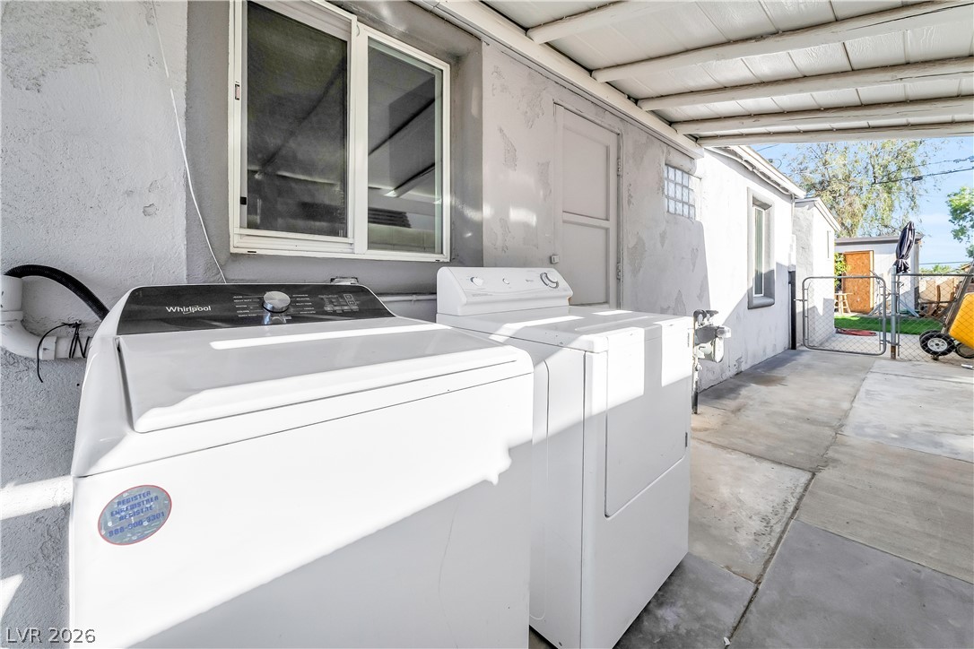 140 West Victory Road Henderson, NV 89015 - Photo 19 of 24 An outdoor laundry area with washer and dryer provides practical utility next to the main building.