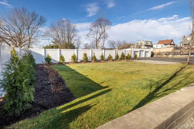 a street view with residential house and trees