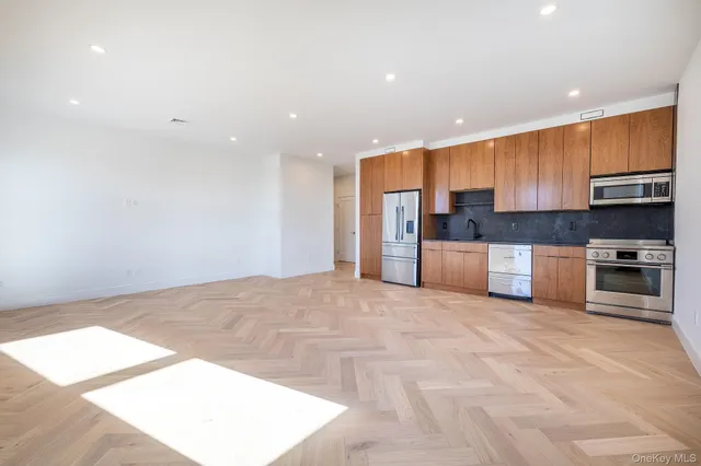 a large kitchen with cabinets and stainless steel appliances