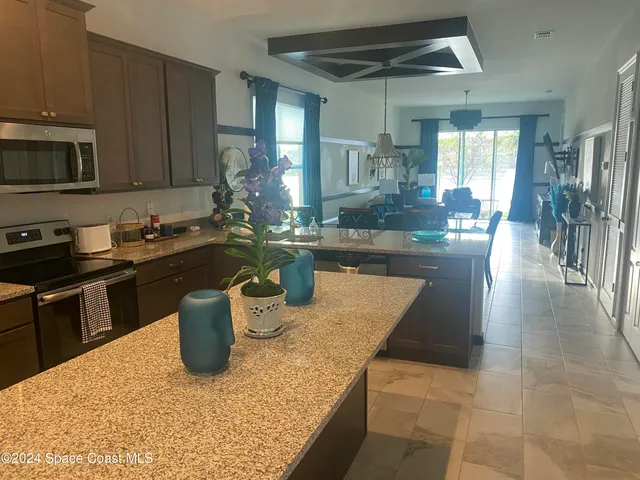 a kitchen with a sink a stove and cabinets