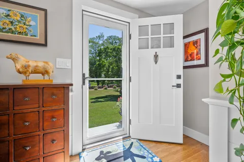 a view of an entryway with wooden floor