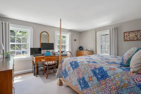 a bedroom with bed and a window