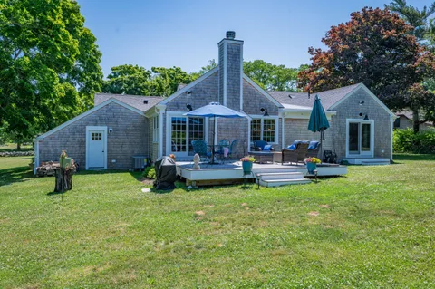 a view of a house with backyard porch and sitting area