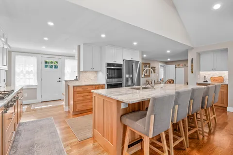 a large kitchen with cabinets table and chairs
