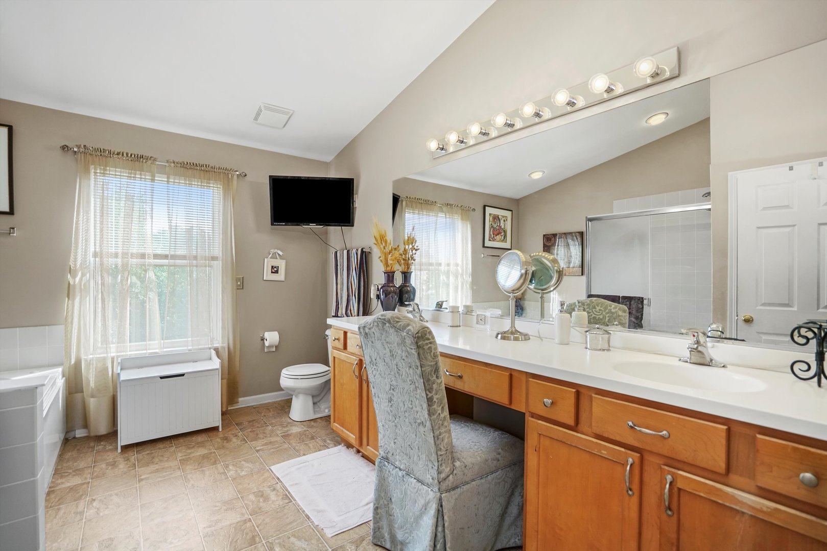351 Claridge Circle Bolingbrook, IL 60440 - Photo 19 of 32 a spacious bathroom with a double vanity sink a mirror and a toilet