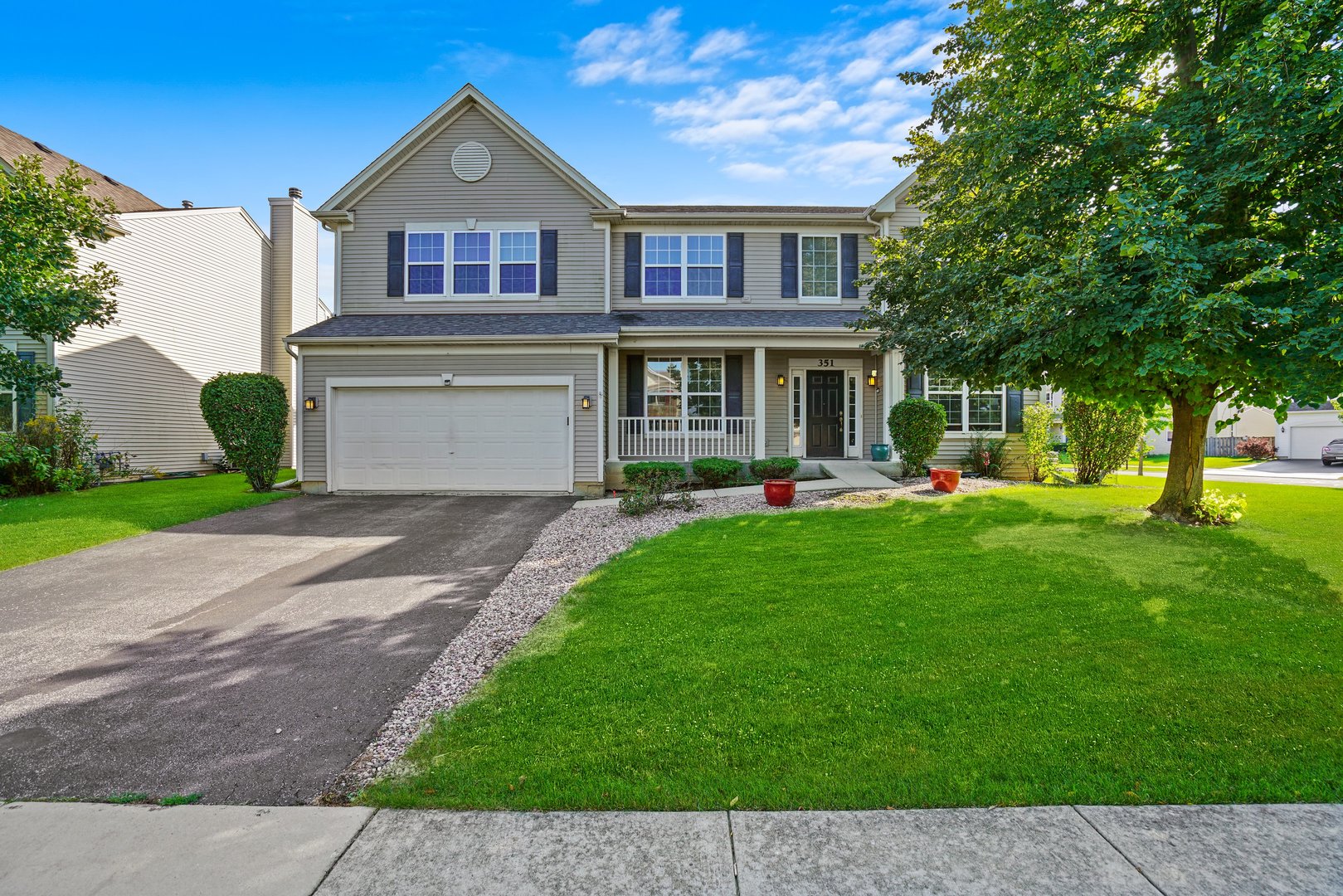 351 Claridge Circle Bolingbrook, IL 60440 - Photo 5 of 32 a front view of a house with garden and trees