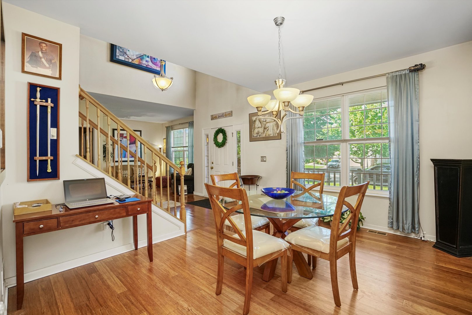351 Claridge Circle Bolingbrook, IL 60440 - Photo 9 of 32 a dining room with furniture a chandelier and wooden floor