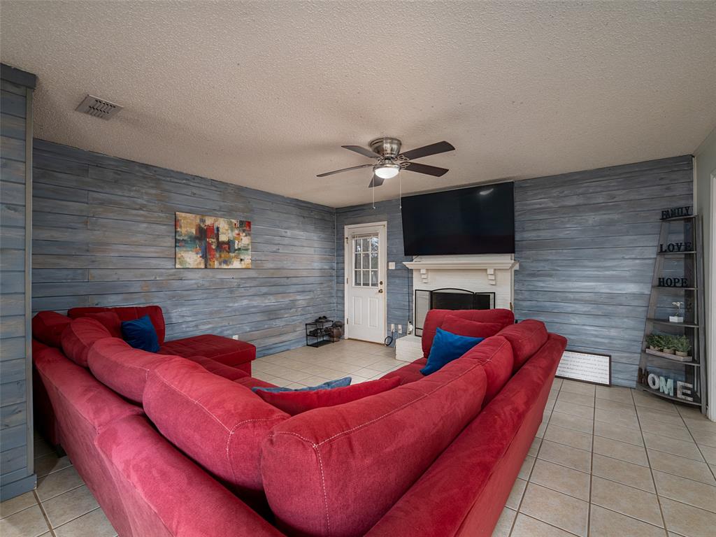 9663 Matise Street Tyler, TX 75706 - Photo 6 of 15 a living room with furniture a flat screen tv and a fireplace
