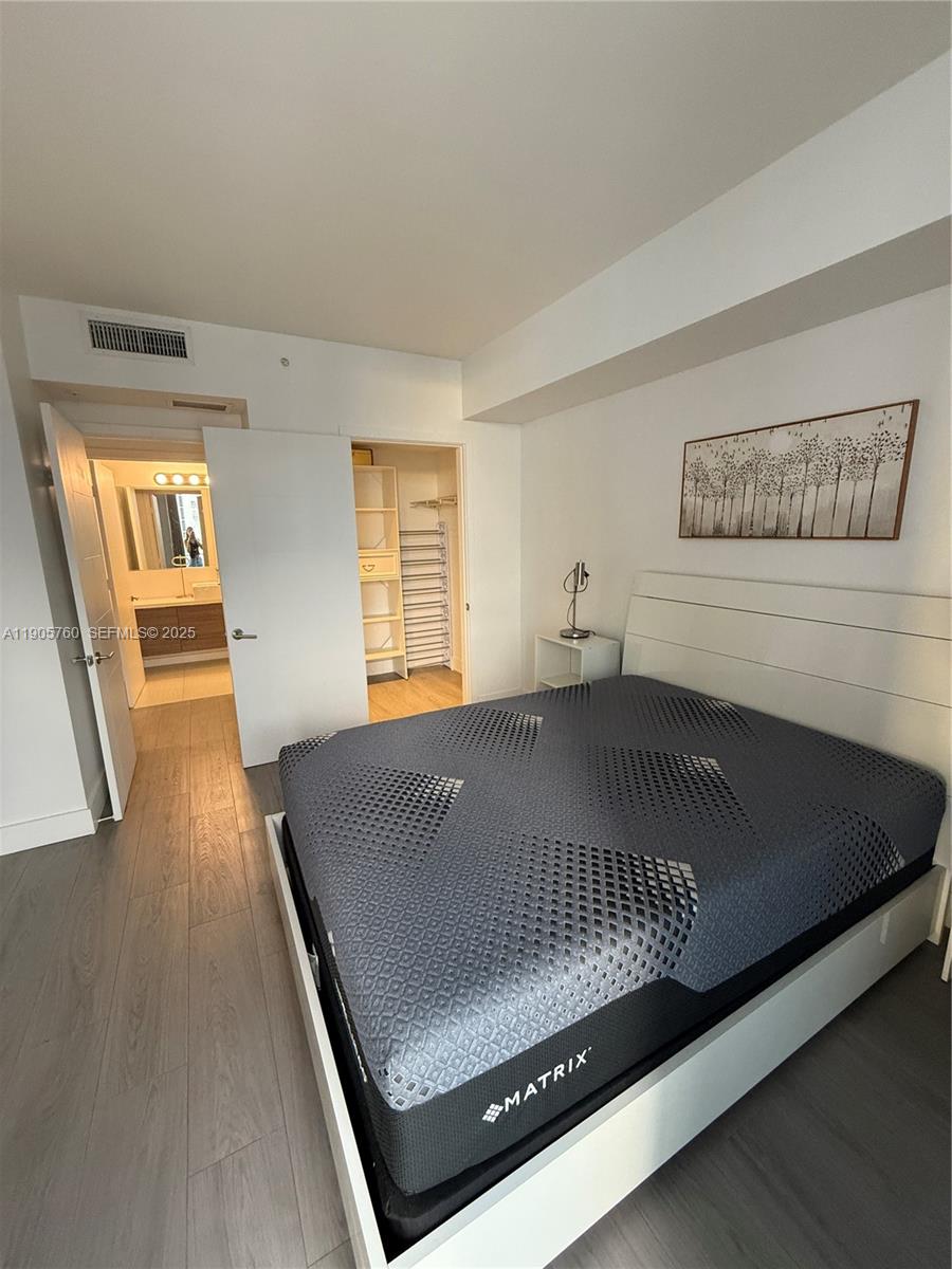 1010 Southwest 2nd Avenue, Unit 910 Miami, FL 33130 - Photo 25 of 32 a view of a bedroom with wooden floor