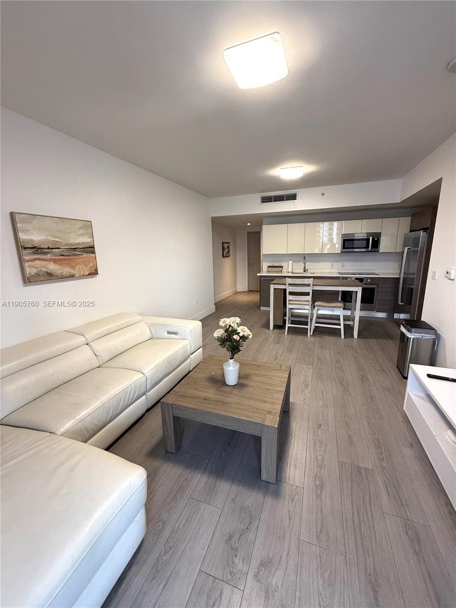 1010 Southwest 2nd Avenue, Unit 910 Miami, FL 33130 - Photo 5 of 32 a living room with furniture and wooden floor