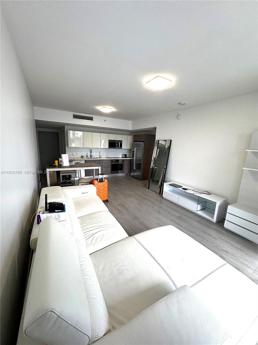 1010 Southwest 2nd Avenue, Unit 910 Miami, FL 33130 - Photo 10 of 32 a kitchen with a sink a counter top space and appliances