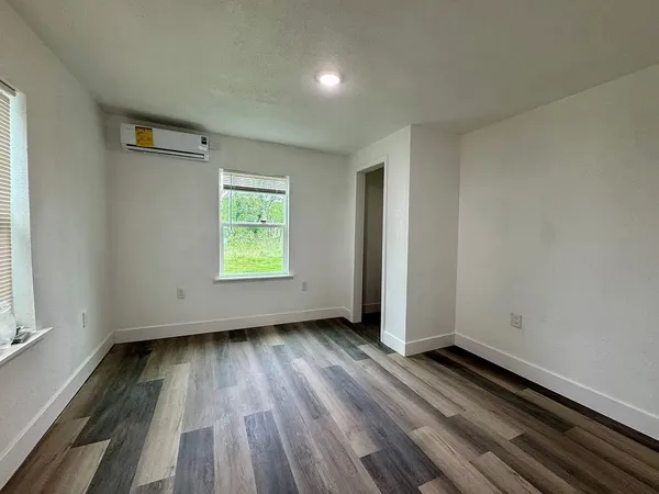 wooden floor in an empty room with a window