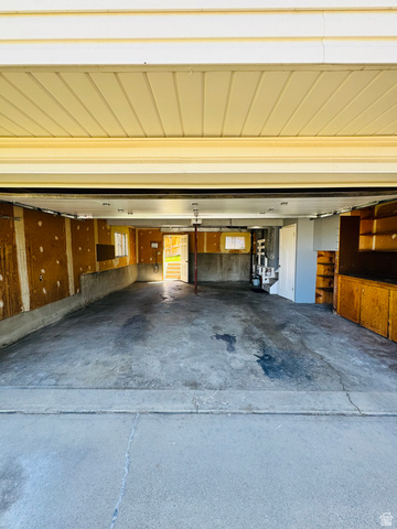 4245 3320 East Holladay, UT 84124 - Photo 45 of 51 Spacious garage featuring a concrete floor, built-in cabinetry, and exposed wall framing