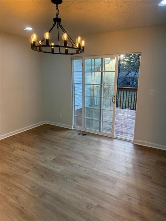 1753 Lee Street Decatur, GA 30035 - Photo 2 of 17 a view of a livingroom with wooden floor and chandelier