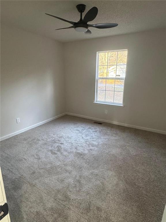1753 Lee Street Decatur, GA 30035 - Photo 8 of 17 an empty room with a window and a fan