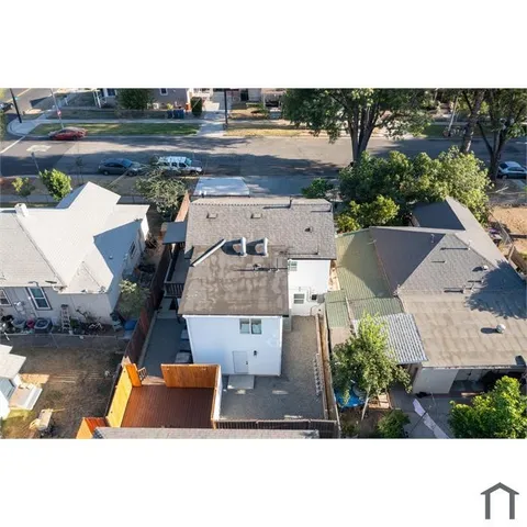an aerial view of a house with a yard basket ball court and outdoor seating