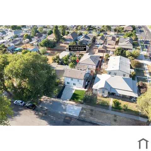 an aerial view of residential houses with outdoor space
