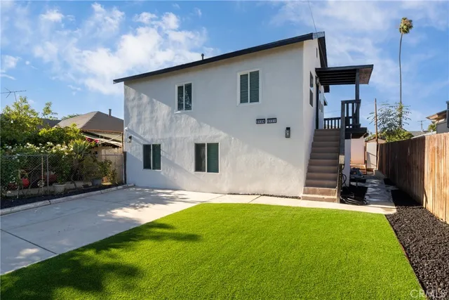 a front view of house with yard and outdoor seating