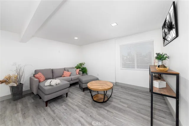 a living room with furniture a window and a potted plant