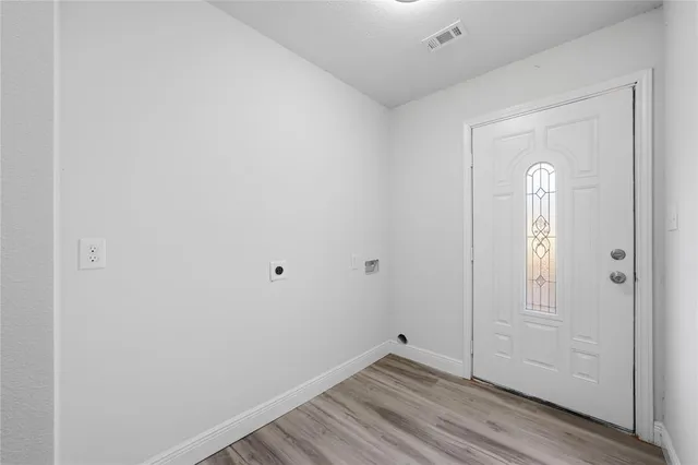 a view of a room with wooden floor and closet area