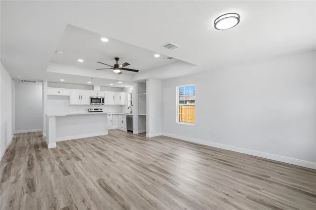 a view of kitchen with wooden floor and window