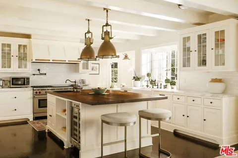 a kitchen with a stove a sink and cabinets