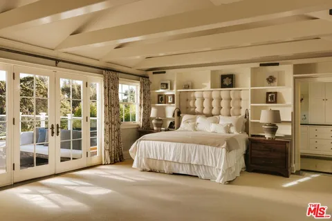 a bedroom with a large bed and a large window