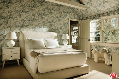 a bedroom with bed and windows