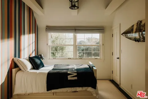 a dining room with furniture and a floor to ceiling window