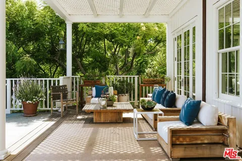 a view of a house with a yard patio and swimming pool