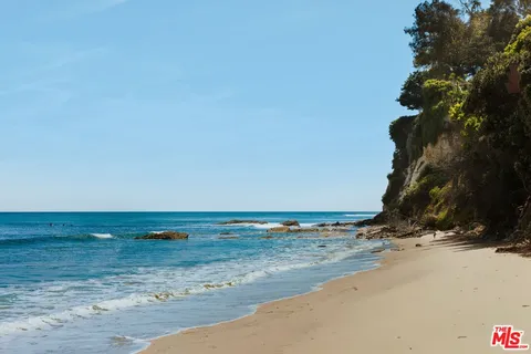 a view of an ocean with a mountain