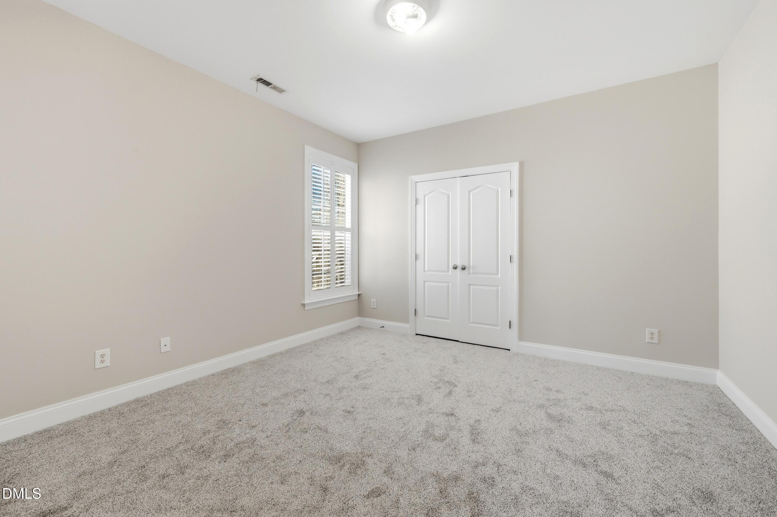 4803 Marena Place Durham, NC 27707 - Photo 28 of 42 an empty room with windows and closet