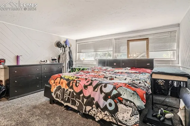 a bedroom with a bed and window