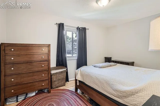 a bedroom with a bed and a mirror