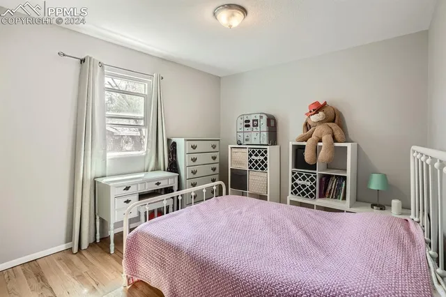 a bedroom with a bed and a television