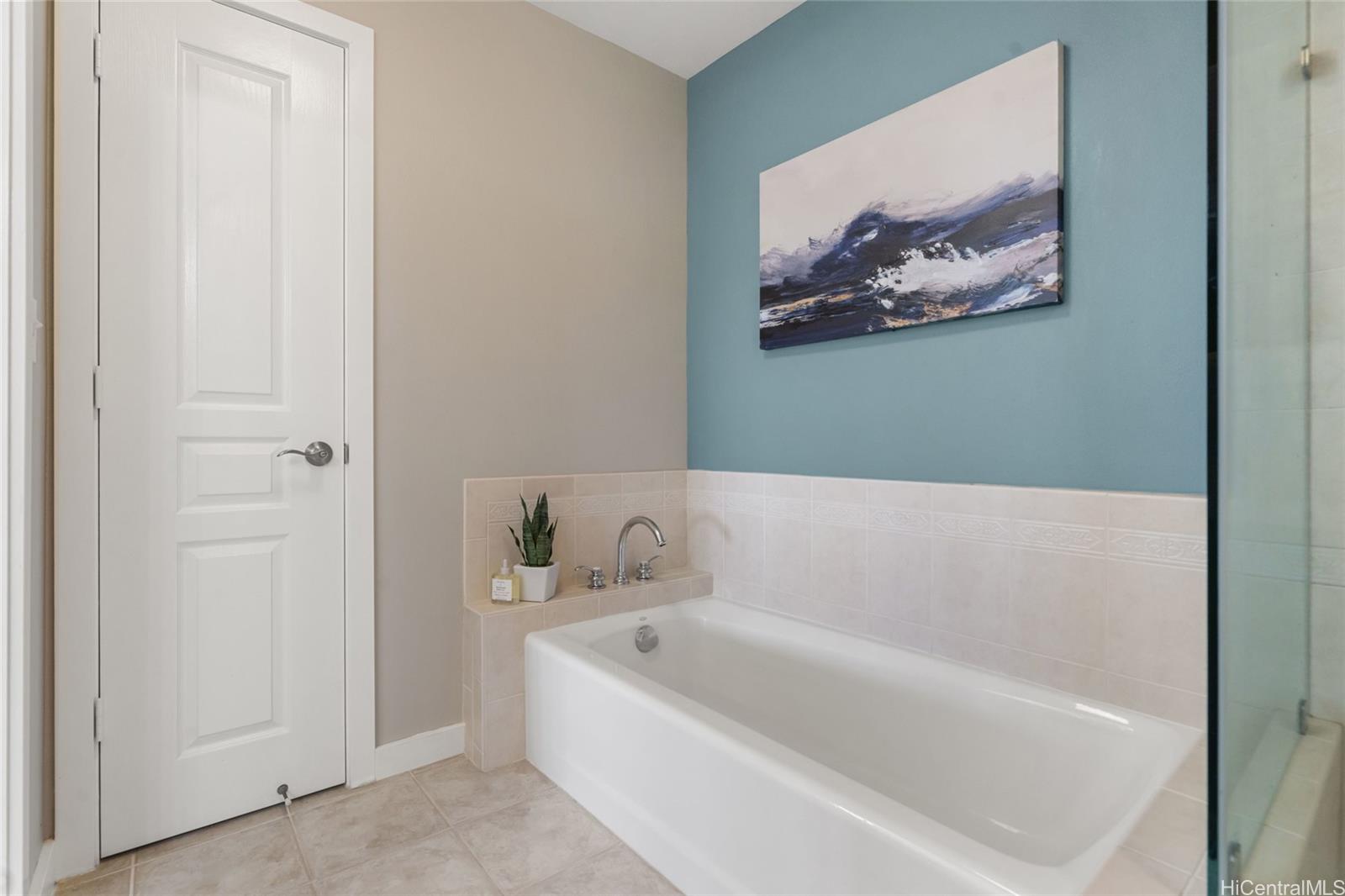 92-1001 Aliinui Drive, Unit 25C Kapolei, HI 96707 - Photo 11 of 25 a bathroom with a bathtub and a painting on the wall