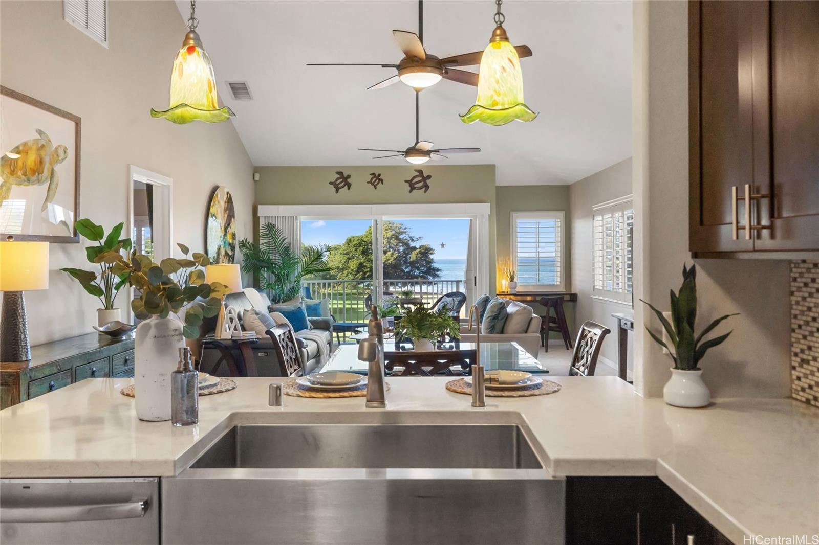92-1001 Aliinui Drive, Unit 25C Kapolei, HI 96707 - Photo 2 of 25 a kitchen counter with a sink and chandelier